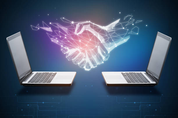 Two laptops with abstract polygonal handshake. Technology, innovation and teamwork concept. 3D Rendering